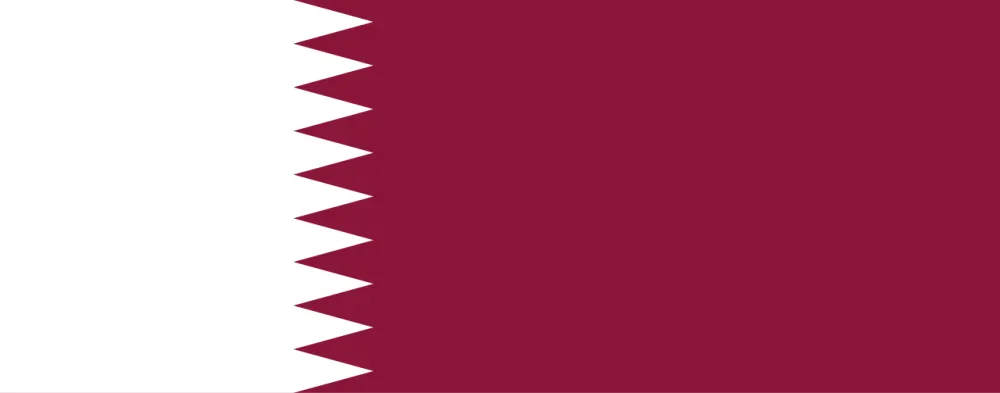 A long maroon flag with a white band along the pole side, joined by a zigzag edge