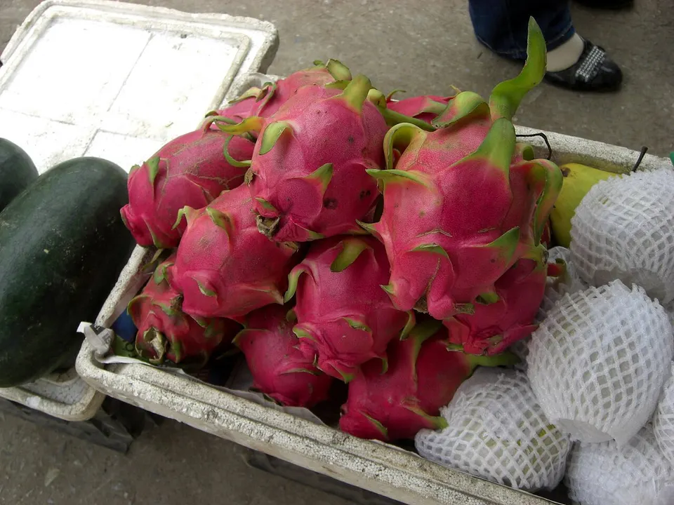Oval pink fruits with green-tipped scales piled together