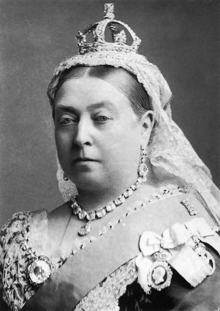 Black-and-white portrait of an older woman wearing a small crown, a lace veil and jewels